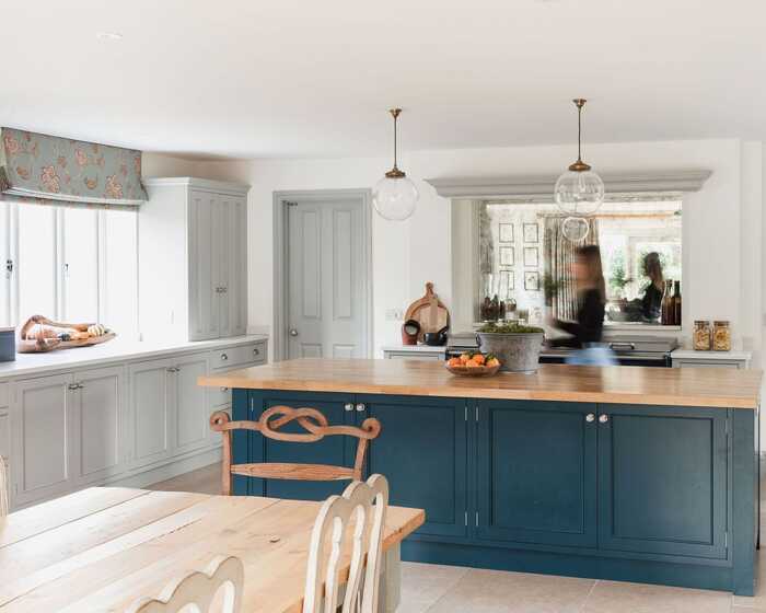 Beautifully design kitchen with blue cabinets on a freestanding kitchen island