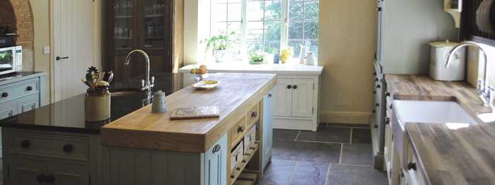 freestanding kitchen island with oak worktops and cabinets