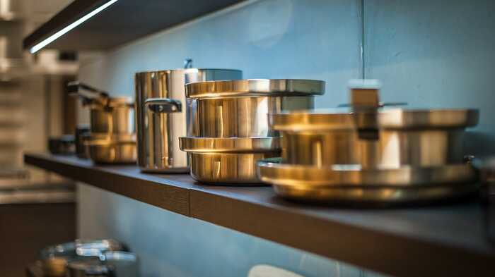 copper pans on shelving 