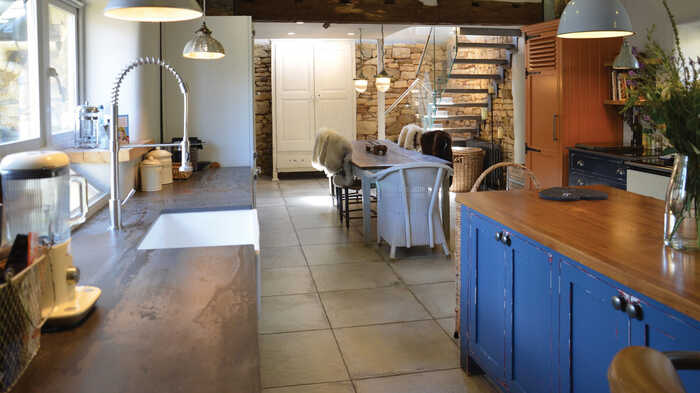 open plan kitchen with stone wall