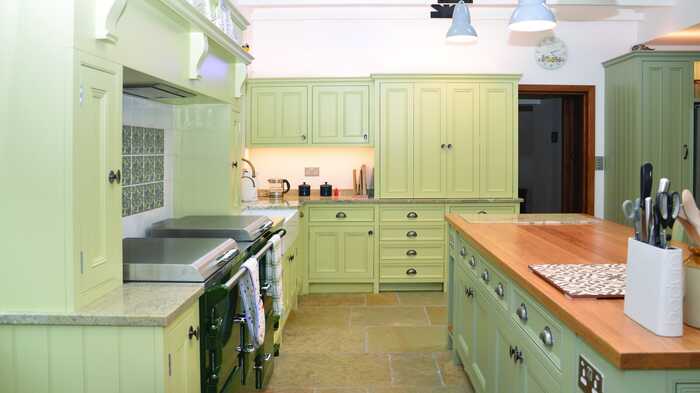 Green kitchen island with cupboards
